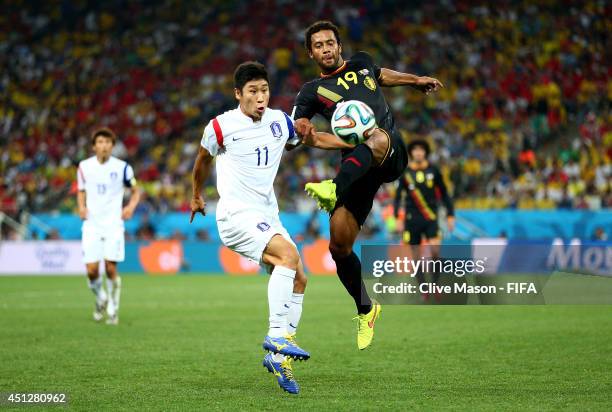 Moussa Dembele of Belgium and Lee Keun-Ho of South Korea compete for the ball during the 2014 FIFA World Cup Brazil Group H match between Korea...