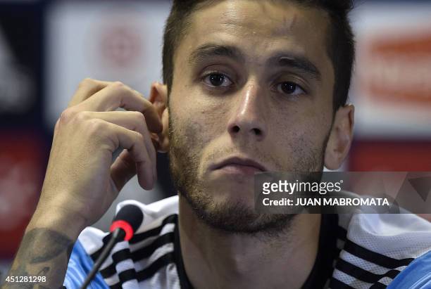 Argentina's midfielder Ricky Alvarez gestures during a press conference at "Cidade do Galo", the base camp in Vespasiano, near Belo Horizonte, on...