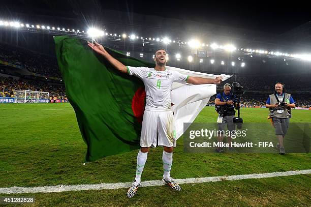 Essaid Belkalem of Algeria celebrates qualifying for the knock out stage after the 1-1 draw in the 2014 FIFA World Cup Brazil Group H match between...