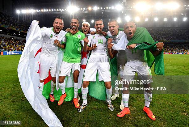 Algeria players celebrate qualifying for the knock out stage after the 1-1 draw in the 2014 FIFA World Cup Brazil Group H match between Algeria and...