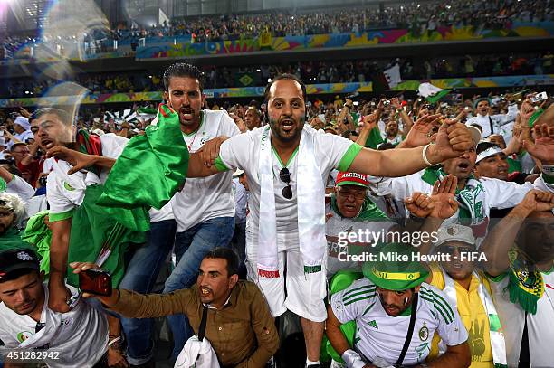 Algeria fans celebrate their team qualifying for the knock out stage after the 1-1 draw in the 2014 FIFA World Cup Brazil Group H match between...