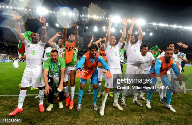 Algeria players and team staffs celebrate qualifying for the knock out stage after the 1-1 draw in the 2014 FIFA World Cup Brazil Group H match...