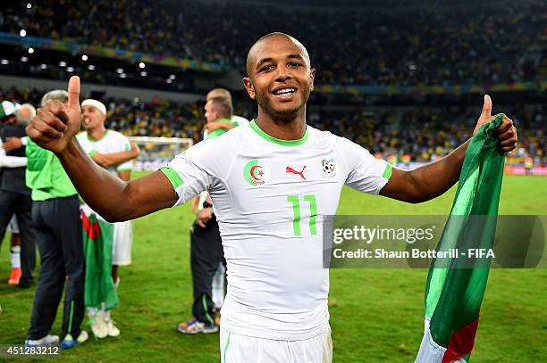 Yacine Brahimi of Algeria celebrates qualifying for the knock out stage after the 1-1 draw in the 2014 FIFA World Cup Brazil Group H match between...