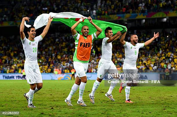 Aissa Mandi and players of Algeria celebrate qualifying for the knock out stage after the 1-1 draw in the 2014 FIFA World Cup Brazil Group H match...