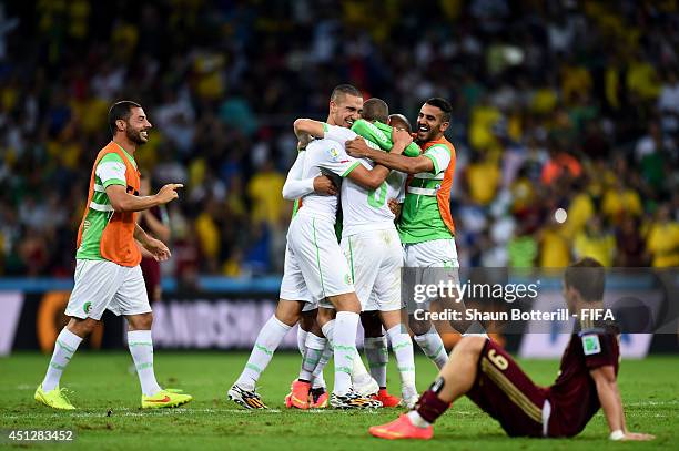 Algeria players celebrate qualifying for the knock out stage while Alexander Kokorin of Russia show his dejection after the 1-1 draw in the 2014 FIFA...