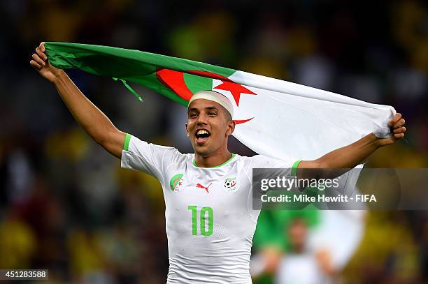 Sofiane Feghouli of Algeria celebrates qualifying for the knock out stage after the 1-1 draw in the 2014 FIFA World Cup Brazil Group H match between...