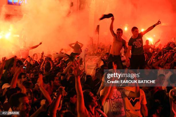 Algerian fans celebrate in Algiers on June 26, 2014 after Algeria eliminated Russia with a 1-1 draw in a FIFA 2014 World Cup Group H match. AFP...