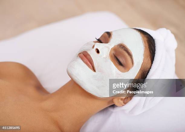 relaxing at the spa - facial cleanse stock pictures, royalty-free photos & images