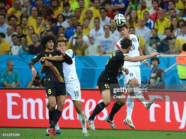Belgium's Daniel Van Buyten vies for the ball with South Korea's Hong Jeongho during the 2014 FIFA World Cup group H soccer match between South Korea...
