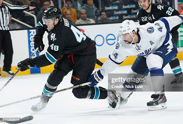 Tomas Hertl of the San Jose Sharks battles up the ice against Nate Thompson of the Tampa Bay Lightning during an NHL game on November 21, 2013 at SAP...