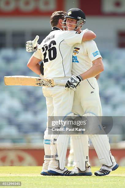 Cameron Bancroft congratulates Marcus North of the Warriors after scoring his century during day one of the Sheffield Shield match between the...