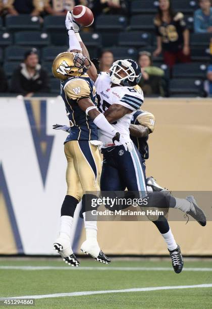 Chris Randle and Maurice Leggett of the Winnipeg Blue Bombers put pressure on John Chiles of the Toronto Argonauts in second half action in a CFL...