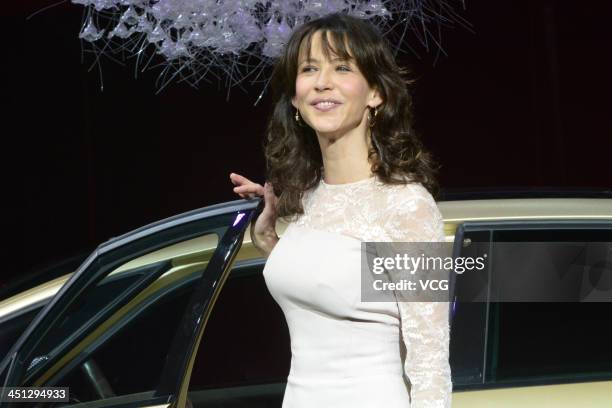 French actress Sophie Marceau poses with a Citroen DS5 during the 11th China International Automobile Exhibition at China Import and Export Fair...