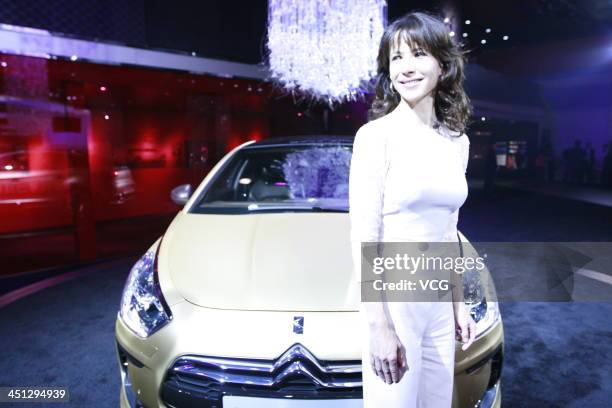 French actress Sophie Marceau poses with a Citroen DS5 during the 11th China International Automobile Exhibition at China Import and Export Fair...