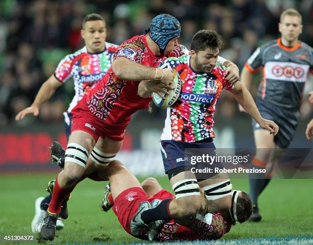 Colby Fainga'a of the Rebels is tackled by James Horwill of the Reds during the round 17 Super Rugby match between the Rebels and the Reds at AAMI...
