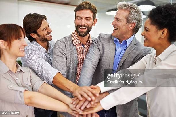 office unity - huddling stock pictures, royalty-free photos & images