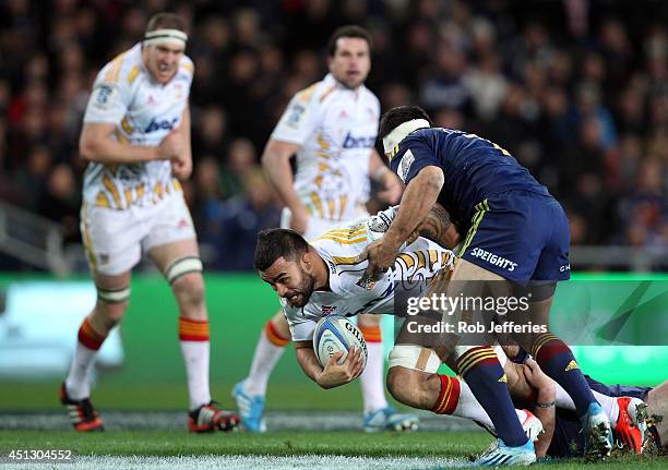 Liam Messam of the Chiefs is tackled by Shane Christie of the Highlanders during the round 17 Super Rugby match between the Highlanders and the...