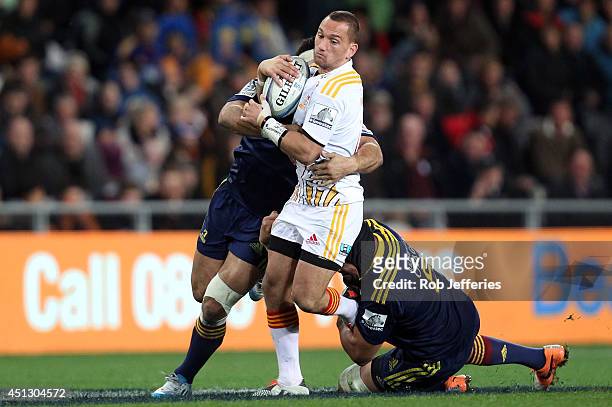 Aaron Cruden of the Chiefs attempts to bust the Highlanders defence during the round 17 Super Rugby match between the Highlanders and the Chiefs at...