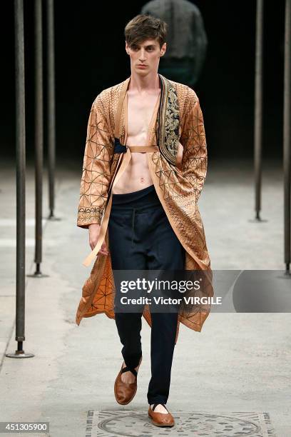 Model walks the runway during the Dries Van Noten show as part of Paris Fashion Week Menswear Spring/Summer 2015 on June 26, 2014 in Paris, France.