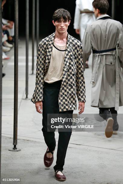 Model walks the runway during the Dries Van Noten show as part of Paris Fashion Week Menswear Spring/Summer 2015 on June 26, 2014 in Paris, France.
