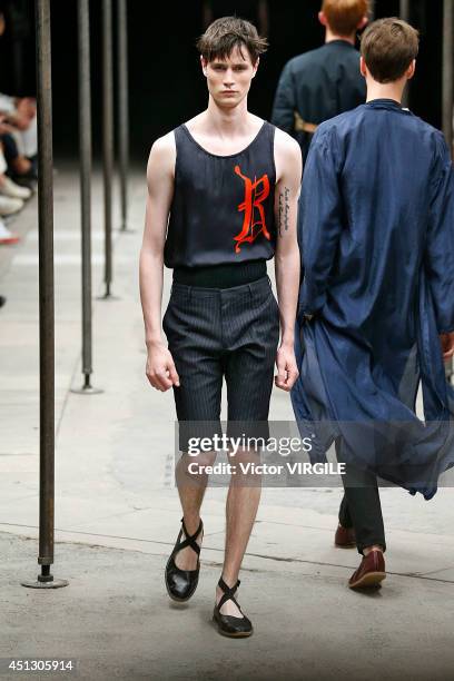 Model walks the runway during the Dries Van Noten show as part of Paris Fashion Week Menswear Spring/Summer 2015 on June 26, 2014 in Paris, France.