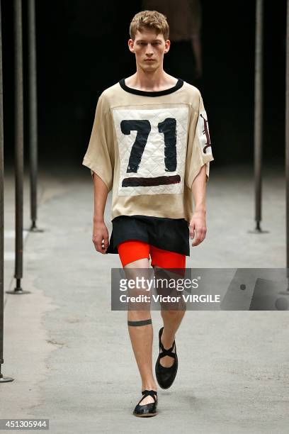 Model walks the runway during the Dries Van Noten show as part of Paris Fashion Week Menswear Spring/Summer 2015 on June 26, 2014 in Paris, France.