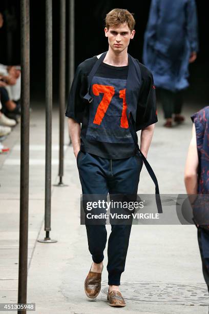 Model walks the runway during the Dries Van Noten show as part of Paris Fashion Week Menswear Spring/Summer 2015 on June 26, 2014 in Paris, France.