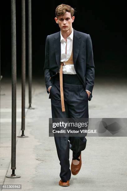 Model walks the runway during the Dries Van Noten show as part of Paris Fashion Week Menswear Spring/Summer 2015 on June 26, 2014 in Paris, France.