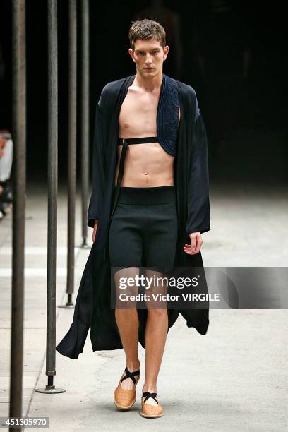 Model walks the runway during the Dries Van Noten show as part of Paris Fashion Week Menswear Spring/Summer 2015 on June 26, 2014 in Paris, France.