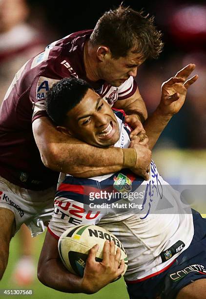 Daniel Tupou of the Roosters is tackled by Brenton Lawrence of the Sea Eagles during the round 16 NRL match between the Manly Warringah Sea Eagles...