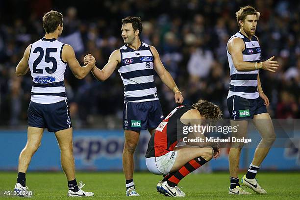 Jared Rivers Jimmy Bartel and Tom Lonergan of the Cats celebrate their win as Joe Daniher of the Bombers reacts during the round 15 AFL match between...