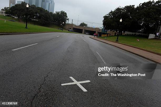 An X in the middle of the road marks the spot where the President was shot. Scenes from Dealey Plaza the location of the assassination of John F....