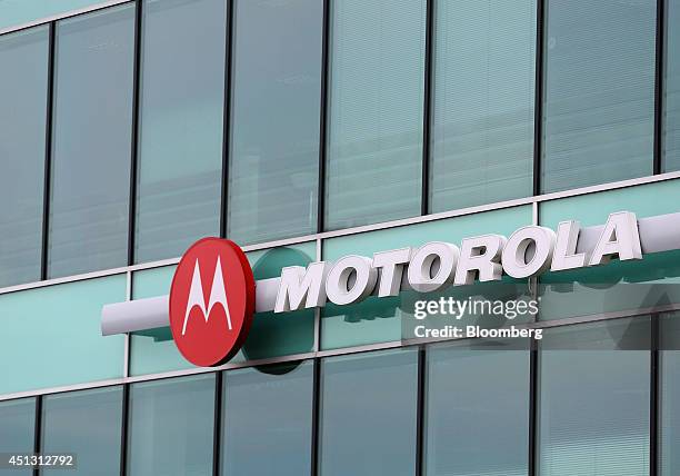 Motorola logo sits outside the glass windows of Motorola Mobility UK Ltd.'s offices in Chineham, U.K., on Friday, June 27, 2014. Google Inc.'s...