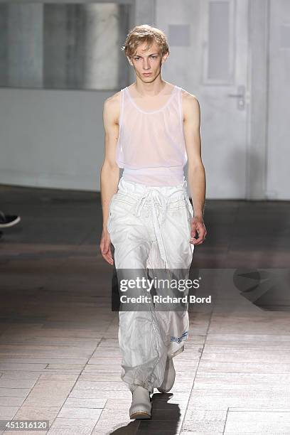 Model walks the runway during the Maison Martin Margiela Man show as part of the Paris Fashion Week Menswear Spring/Summer 2015 on June 27, 2014 in...