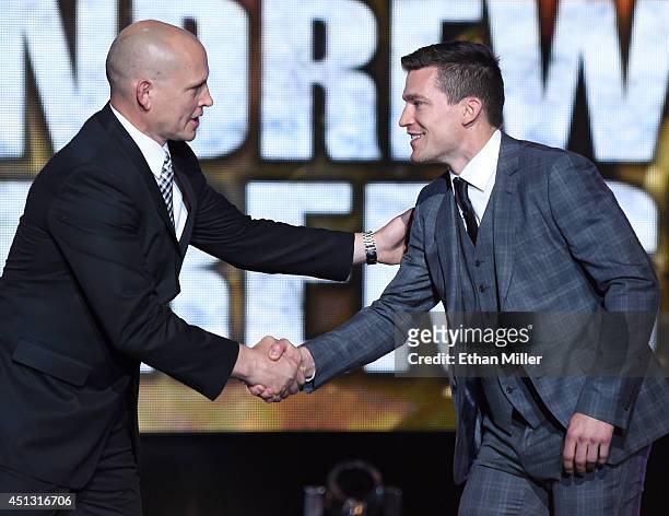 Former NHL player Adam Graves presents Andrew Ference of the Edmonton Oilers with the King Clancy Memorial Trophy during the 2014 NHL Awards at the...