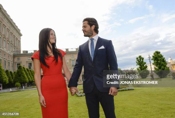 Swedish Prince Carl Philip poses with former model Sofia Hellqvist in the garden of the Stockholm Palace, on June 27, 2014 during a press statement...