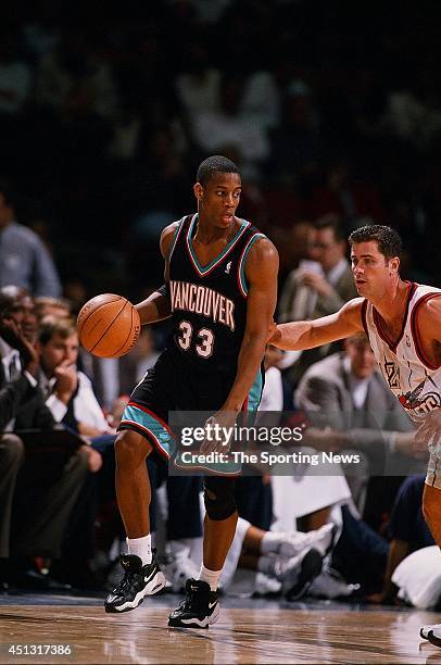 Antonio Daniels of the Vancouver Grizzlies moves the ball past Matt Maloney of the Houston Rockets during the game on December 16, 1997 at the Compaq...