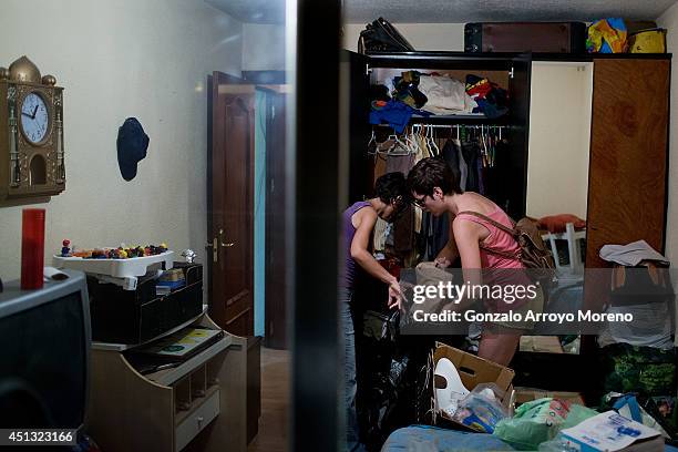 Activists of the Victims Mortgage Platform pack up Jorge Aviles family personal belongings in one of the bedrooms prior to start his third eviction...