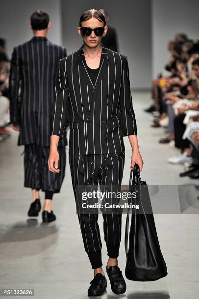 Model walks the runway at the Juun.J Spring Summer 2015 fashion show during Paris Menswear Fashion Week on June 27, 2014 in Paris, France.