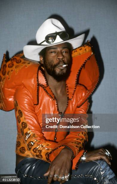 Musician George Clinton takes a puff of a joint during a portrait session backstage in November 1976.