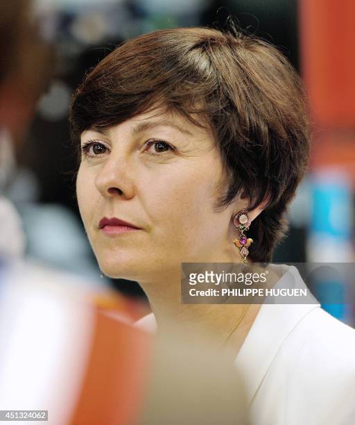French Trade and Handicraft Junior Minister Carole Delga listens as she visits a trade center on June 27 in Faches-Thumesnil, northern France. AFP...
