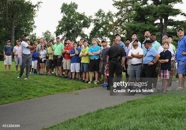 Tiger Woods of the United States hits his chip shot on the second hole during the second round of the Quicken Loans National at Congressional Country...