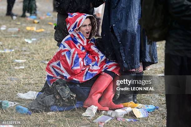 Festivalgoers face up to the heavy rain, on the first official day of the Glastonbury Festival of Music and Performing Arts in Somerset, southwest...