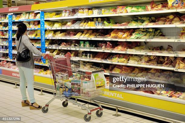 Woman looks for products as she buys groceries in an Auchan supermarket, a branch of the French international retail group Auchan, on June 27 in a...