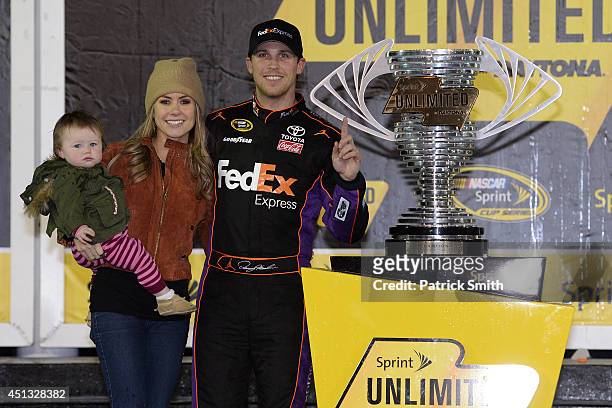 Denny Hamlin, driver of the FedEx Express Toyota, celebrates in victory lane with Jordan Fish and daughter Taylor during the NASCAR Sprint Cup Series...