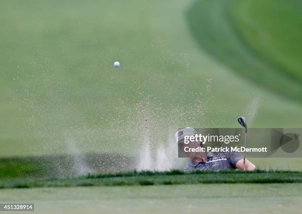 Ricky Barnes of the United States hits out of the sand trap on the 15th hole during the second round of the Quicken Loans National at Congressional...