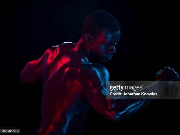 profile of athletic male , arm raised, movement - combat sport stock pictures, royalty-free photos & images