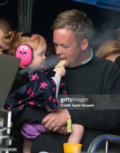 Sam Cooper and daughter Marnie Rose Cooper watch Lily Allen from side of stage at the Glastonbury Festival at Worthy Farm on June 27, 2014 in...