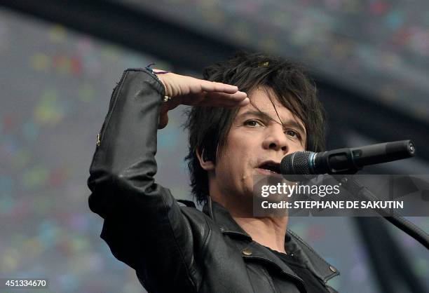 French singer Nicolas Sirkis from Indochine band gestures as he performs on June 27, 2014 during a concert at the Stade de France, in Saint-Denis,...