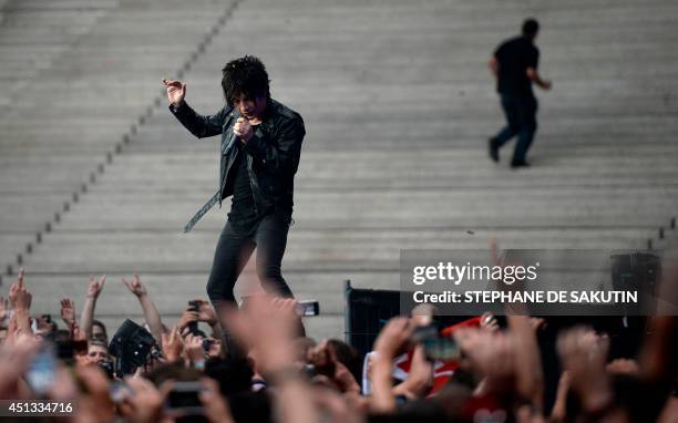 French singer Nicolas Sirkis from Indochine band gestures as he performs on June 27, 2014 during a concert at the Stade de France, in Saint-Denis,...